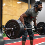 a man working out with a barbell at the Rodney Parham club