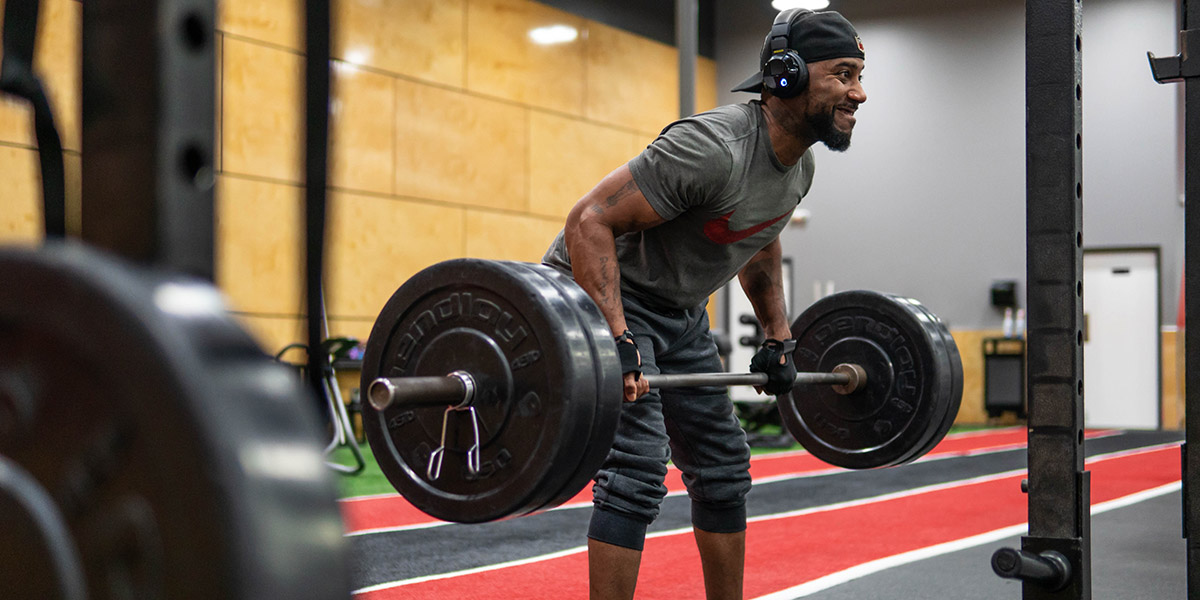 a man working out with a barbell at the Rodney Parham club