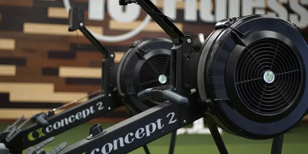Person using rowing machine at 10 Fitness gym in Arkansas