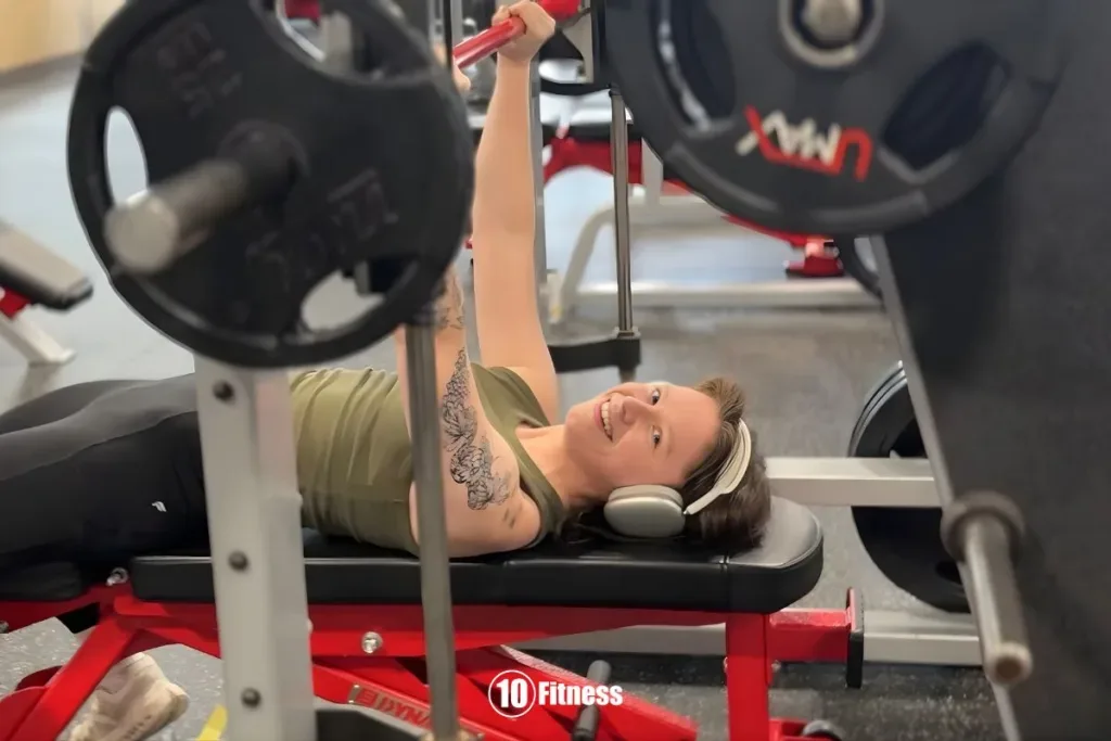 Person performing beginner chest workout exercises in gym setting