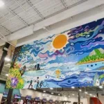 Large colorful mural overlooking the workout floor at 10 Fitness Bowman